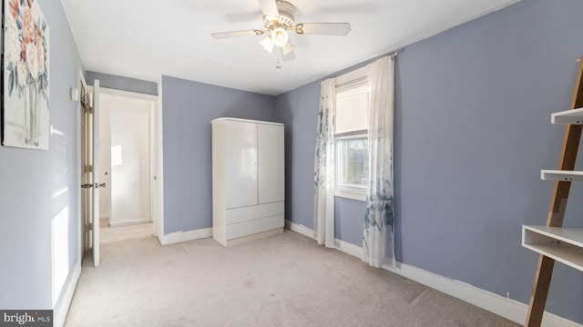 unfurnished bedroom with a ceiling fan, baseboards, and carpet flooring