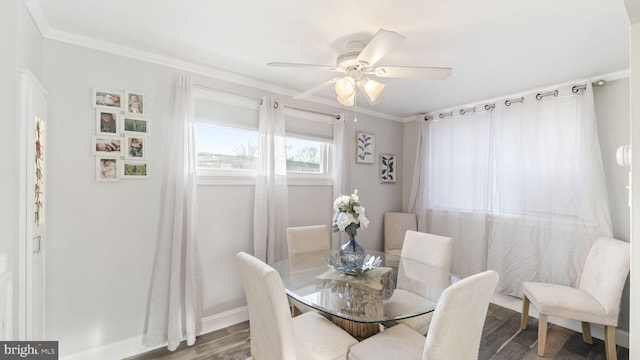 dining space with crown molding, baseboards, ceiling fan, and wood finished floors