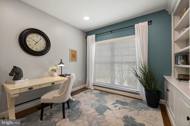 office space featuring baseboards and wood finished floors