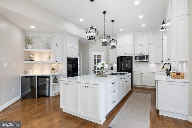 kitchen with stainless steel microwave, wine cooler, light countertops, and open shelves