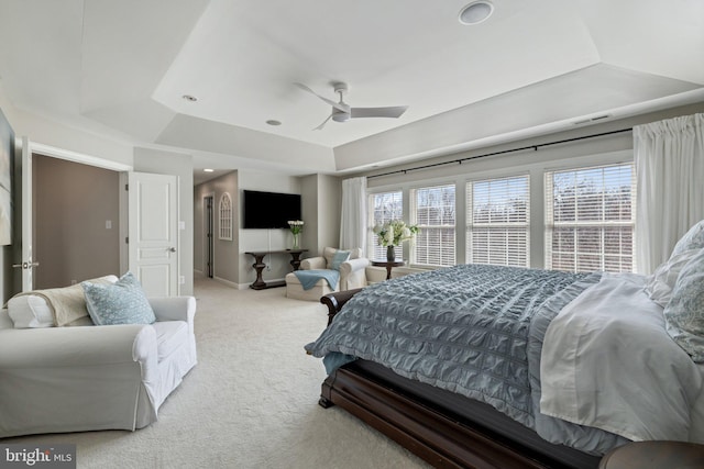 carpeted bedroom with visible vents, baseboards, a tray ceiling, recessed lighting, and ceiling fan