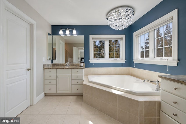 bathroom with tile patterned floors, vanity, and a garden tub