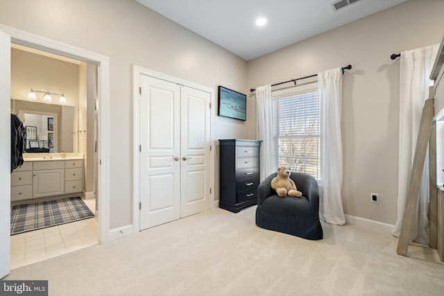 living area with recessed lighting, baseboards, and light carpet