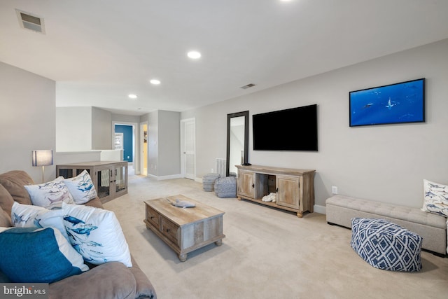 living room featuring light carpet, visible vents, recessed lighting, and baseboards