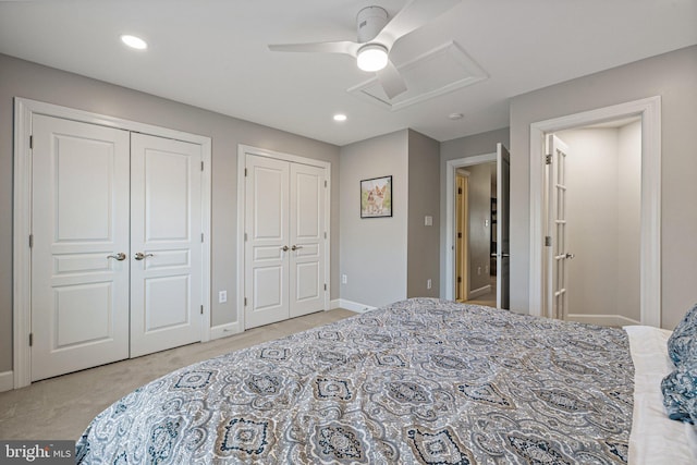 carpeted bedroom featuring attic access, recessed lighting, baseboards, and multiple closets