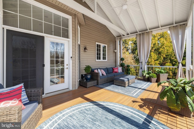 sunroom / solarium with lofted ceiling with beams