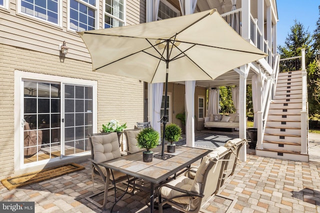 view of patio with stairway and outdoor dining area