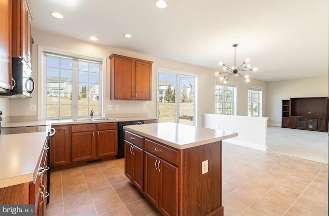 kitchen featuring a sink, brown cabinetry, and dishwasher