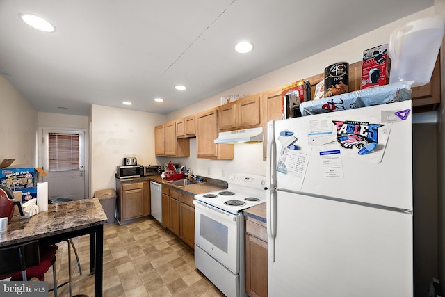 kitchen with light brown cabinets, recessed lighting, under cabinet range hood, white appliances, and a sink