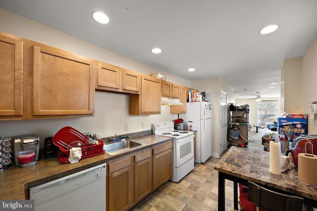 kitchen featuring recessed lighting, white appliances, a sink, and under cabinet range hood