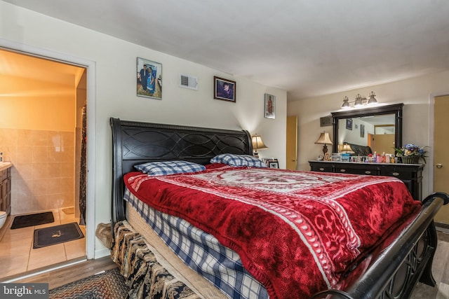 bedroom with visible vents and wood finished floors