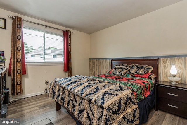 bedroom with wood finished floors and baseboards