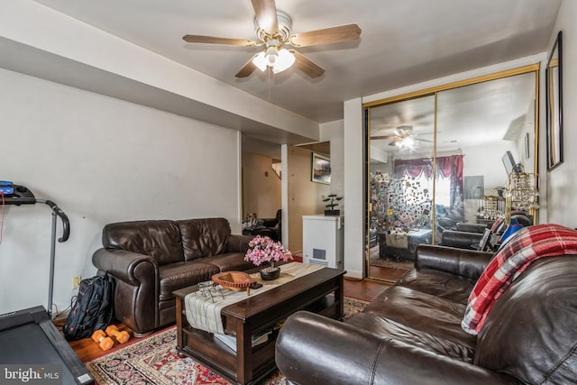 living area with ceiling fan and wood finished floors