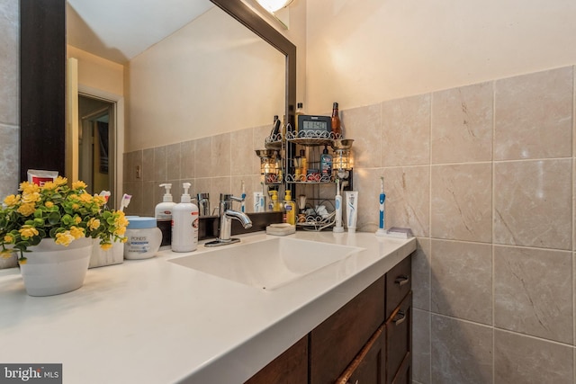 bathroom with tile walls and vanity