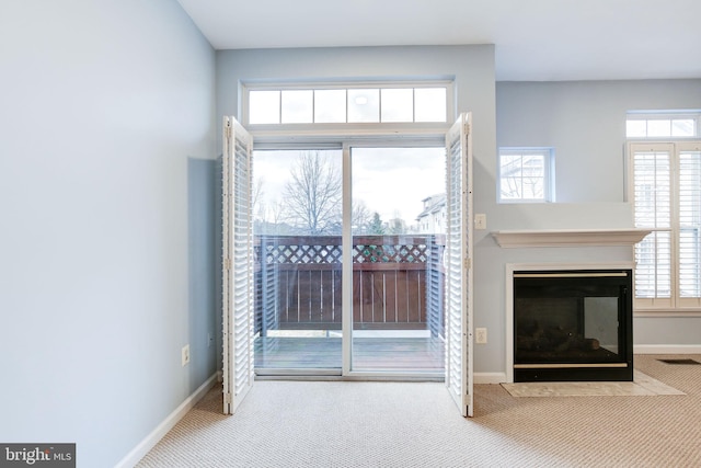 unfurnished living room with carpet floors, visible vents, baseboards, and a multi sided fireplace