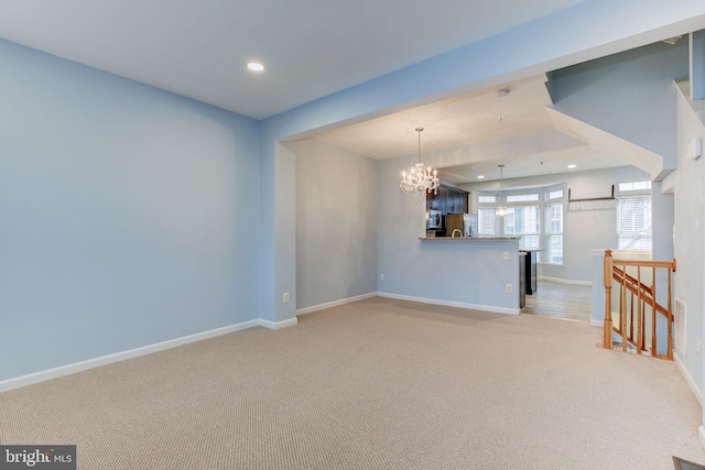 interior space with a chandelier, recessed lighting, light carpet, and baseboards