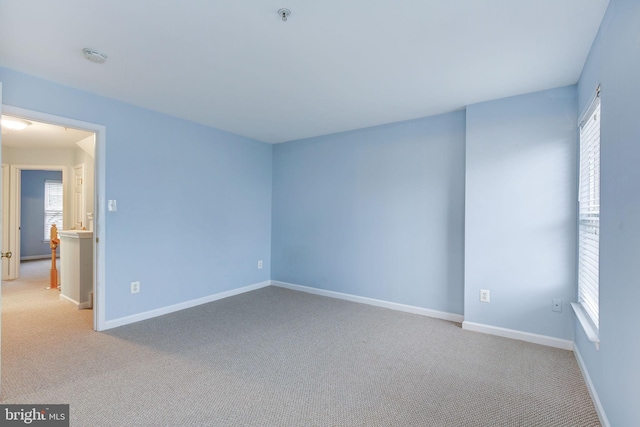 empty room with carpet floors and baseboards