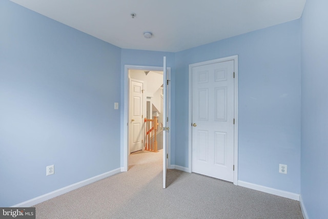 unfurnished bedroom with carpet floors and baseboards