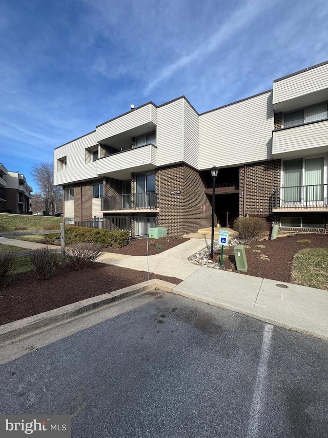 view of property featuring uncovered parking