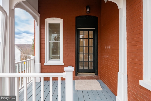 property entrance featuring brick siding