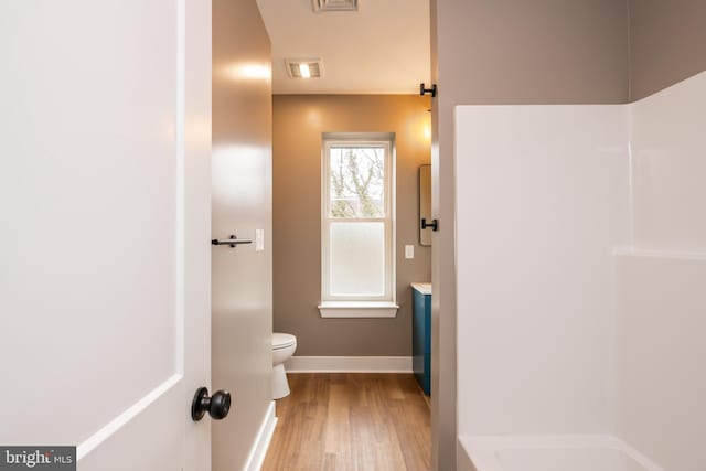 full bathroom with toilet, wood finished floors, vanity, visible vents, and baseboards