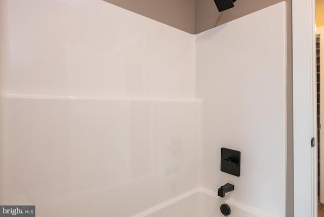 interior details featuring tub / shower combination