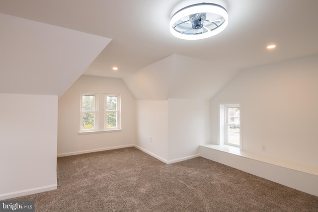 additional living space with lofted ceiling, baseboards, carpet, and recessed lighting