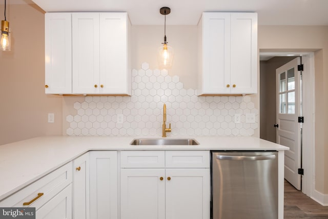 kitchen featuring light countertops, white cabinets, dishwasher, and a sink