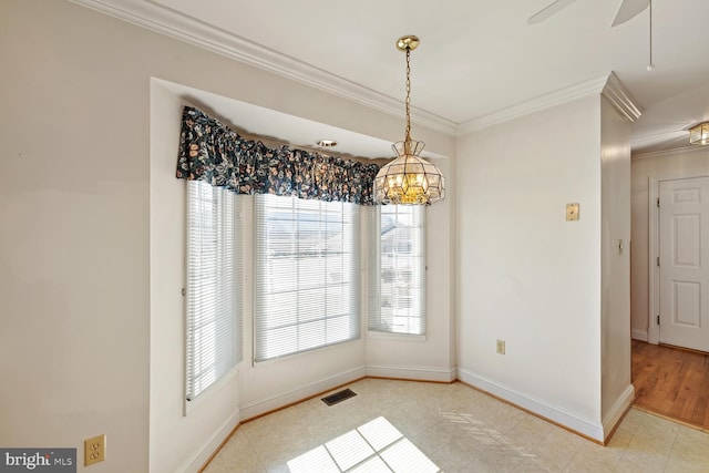 unfurnished dining area featuring crown molding, baseboards, visible vents, and ceiling fan