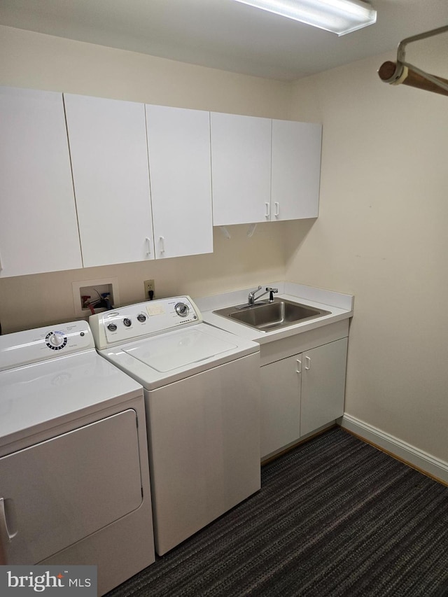 washroom with washer and clothes dryer, cabinet space, baseboards, and a sink