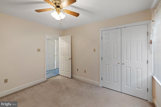 unfurnished bedroom featuring a closet, baseboards, ceiling fan, and carpet flooring