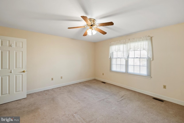 spare room with visible vents, carpet flooring, and baseboards