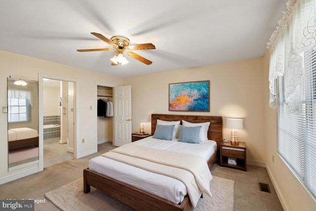 bedroom featuring a closet, visible vents, light colored carpet, and baseboards