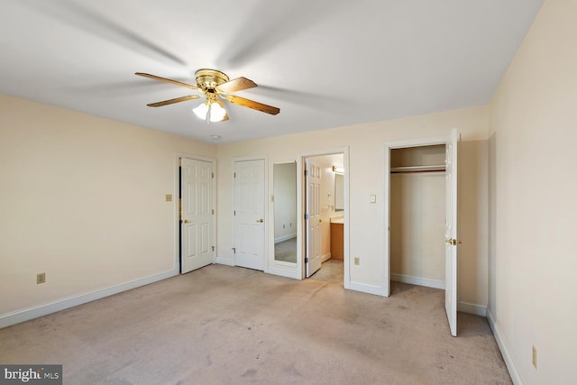 unfurnished bedroom featuring connected bathroom, baseboards, light colored carpet, and ceiling fan