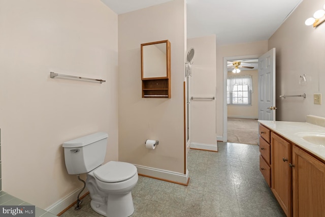 bathroom featuring tile patterned floors, baseboards, toilet, and vanity