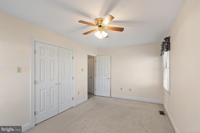 unfurnished bedroom with visible vents, baseboards, carpet floors, a closet, and a ceiling fan