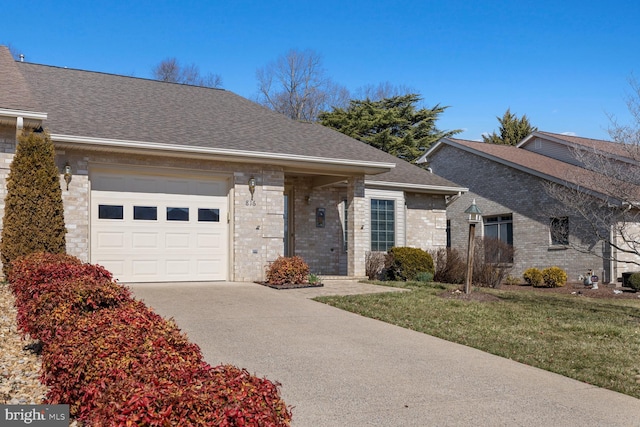 ranch-style home featuring a front yard, driveway, roof with shingles, an attached garage, and brick siding