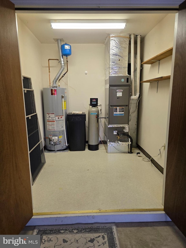 utility room featuring water heater