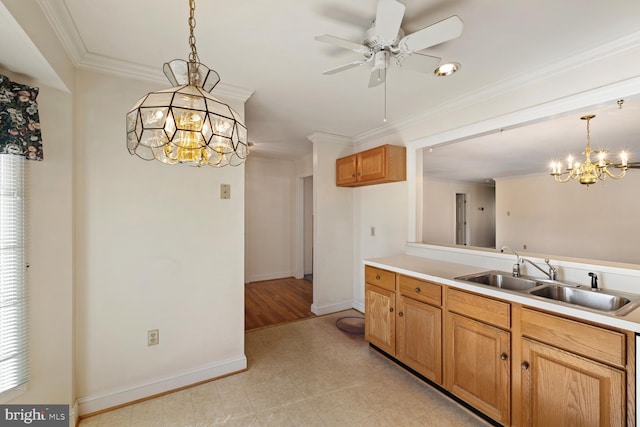 kitchen with crown molding, decorative light fixtures, light floors, and a sink