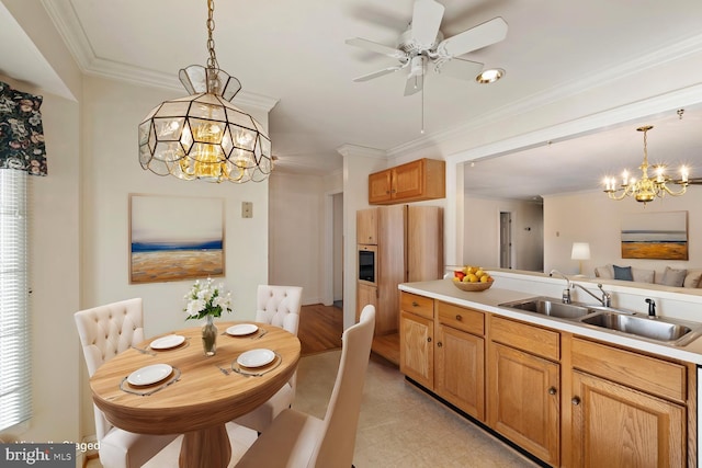 kitchen with pendant lighting, light countertops, crown molding, and a sink