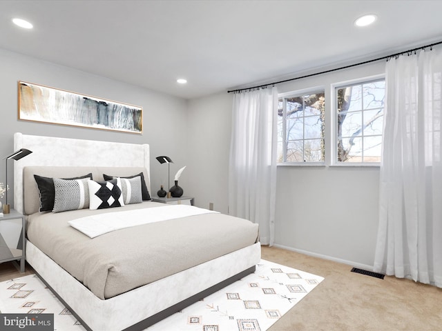 bedroom featuring baseboards, recessed lighting, visible vents, and light carpet