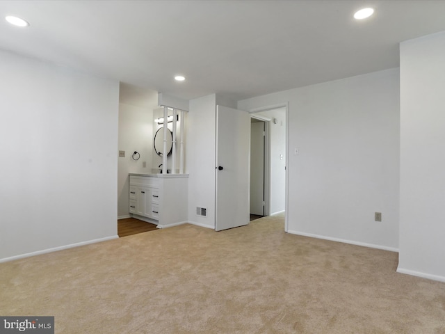 unfurnished bedroom with visible vents, recessed lighting, light colored carpet, and baseboards