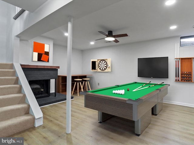 playroom featuring a fireplace with raised hearth, pool table, a ceiling fan, and wood finished floors