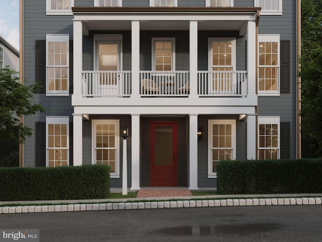 view of front of house with covered porch and a balcony