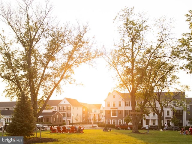 view of property's community with a residential view and a yard