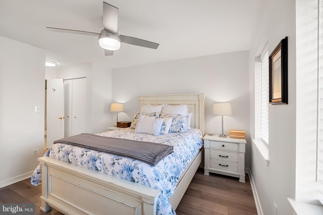 bedroom with ceiling fan, dark wood finished floors, and baseboards