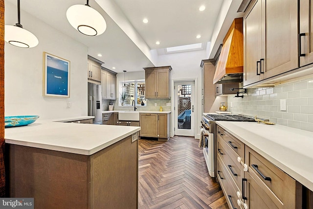 kitchen with recessed lighting, light countertops, stainless steel refrigerator with ice dispenser, decorative backsplash, and gas range