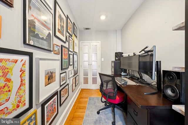 office area with french doors, visible vents, and light wood-style flooring