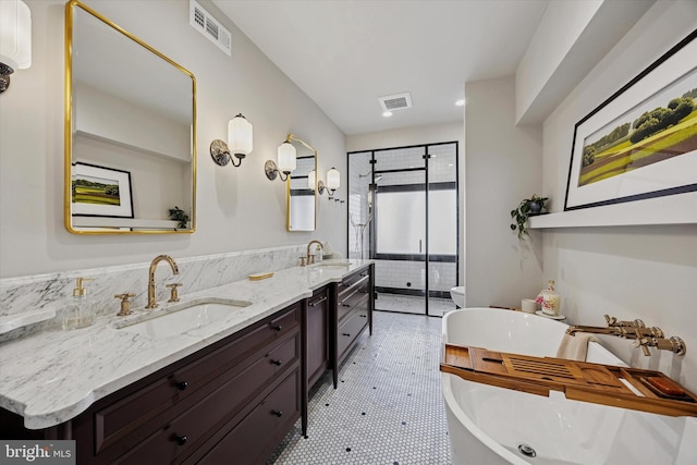 bathroom featuring visible vents, a sink, a shower stall, and double vanity