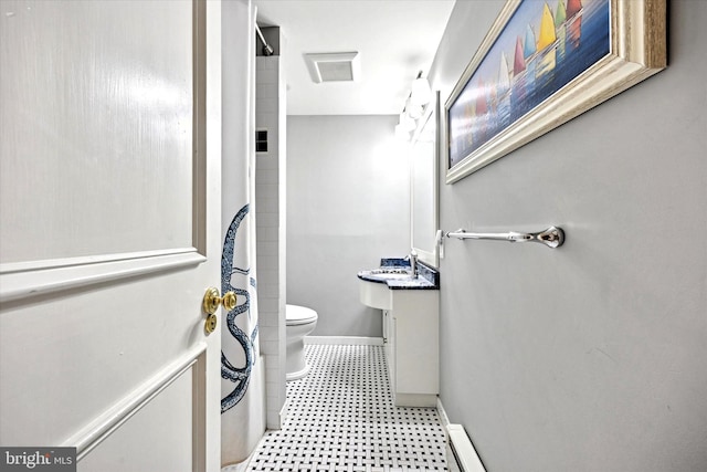 bathroom with curtained shower, toilet, vanity, baseboards, and tile patterned floors